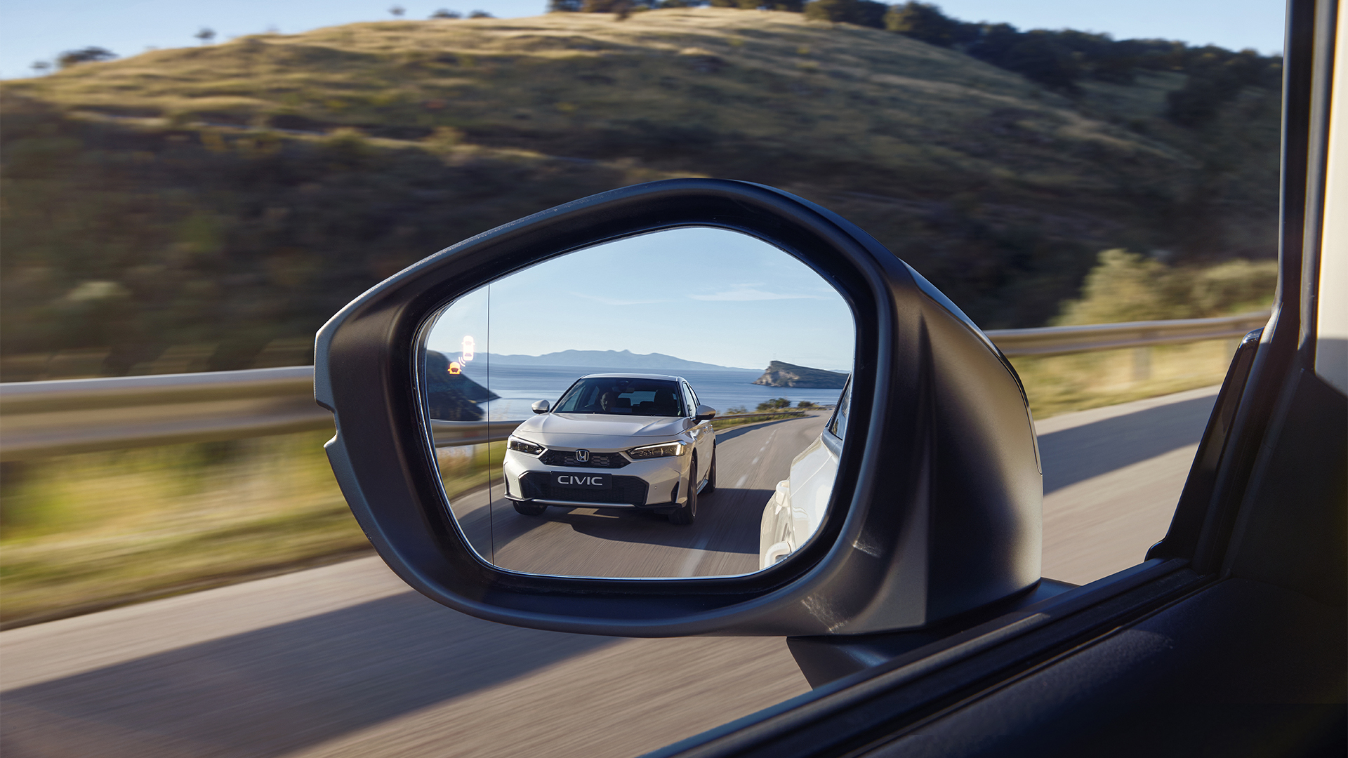 An image of the Civic Hybrid shot in a wing mirror.