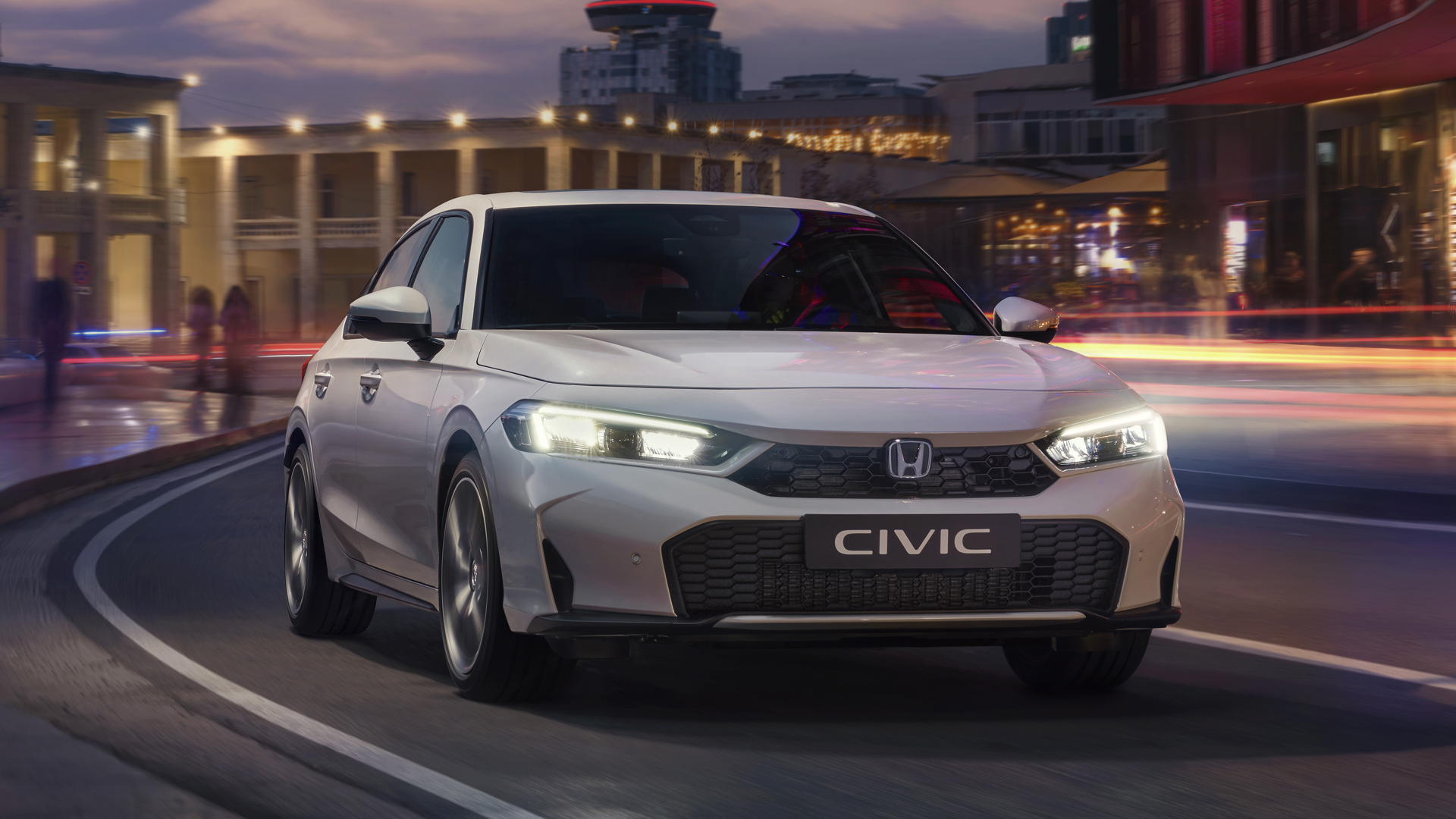 Civic Hybrid in a city, on the road, at dawn